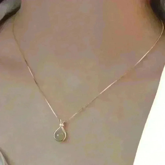 Jade Stone encased in a sleek gold necklace, accented with a sparkling c… - Picture 4 of 4